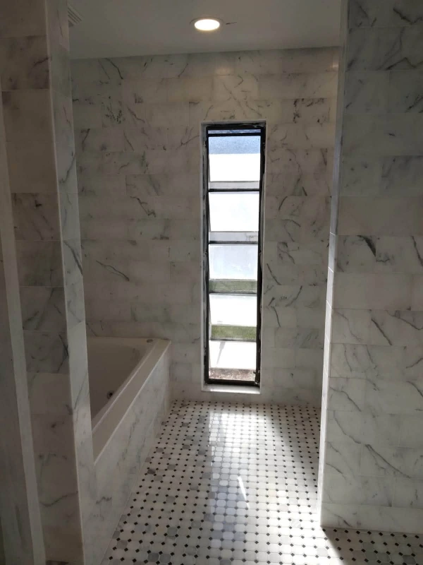 Large-format porcelain tile installation in a Sarasota, FL bathroom