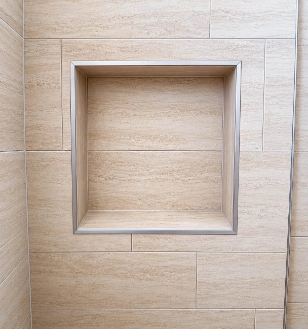 Tile setter installing porcelain in a Sarasota shower, one of the largest line items in a bathroom remodel
